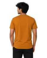 Male model backside wearing a rustic orange Supima cotton T-shirt with a minimalist crew neck design.