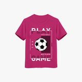 A pink crew neck t-shirt with short sleeves, featuring a graphic print of a soccer ball and the text 'PLAY THE GAME'.