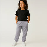 Child wearing a Suvin Gold Cotton black t-shirt and gray sweatpants on a white background