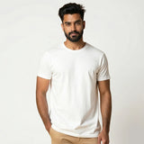 Man wearing a plain white t-shirt against a light gray background