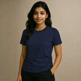 Woman wearing a Suvin Gold Cotton navy blue t-shirt against a beige background