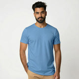 Man wearing a Suvin Gold Cotton light blue t-shirt against a white background