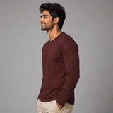 Man wearing burgundy full sleeve Suvin Gold cotton t-shirt side view showing wine red silhouette and slim fit