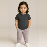 Child wearing a Suvin Cotton Gray  t-shirt and light purple pants on a beige background