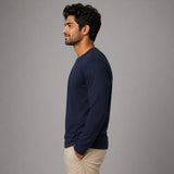 Man wearing navy blue full sleeve Suvin Gold cotton t-shirt side view showing slim silhouette and cuff detail