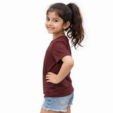 Young girl wearing a maroon suvin gold cotton t-shirt and denim shorts on a white background